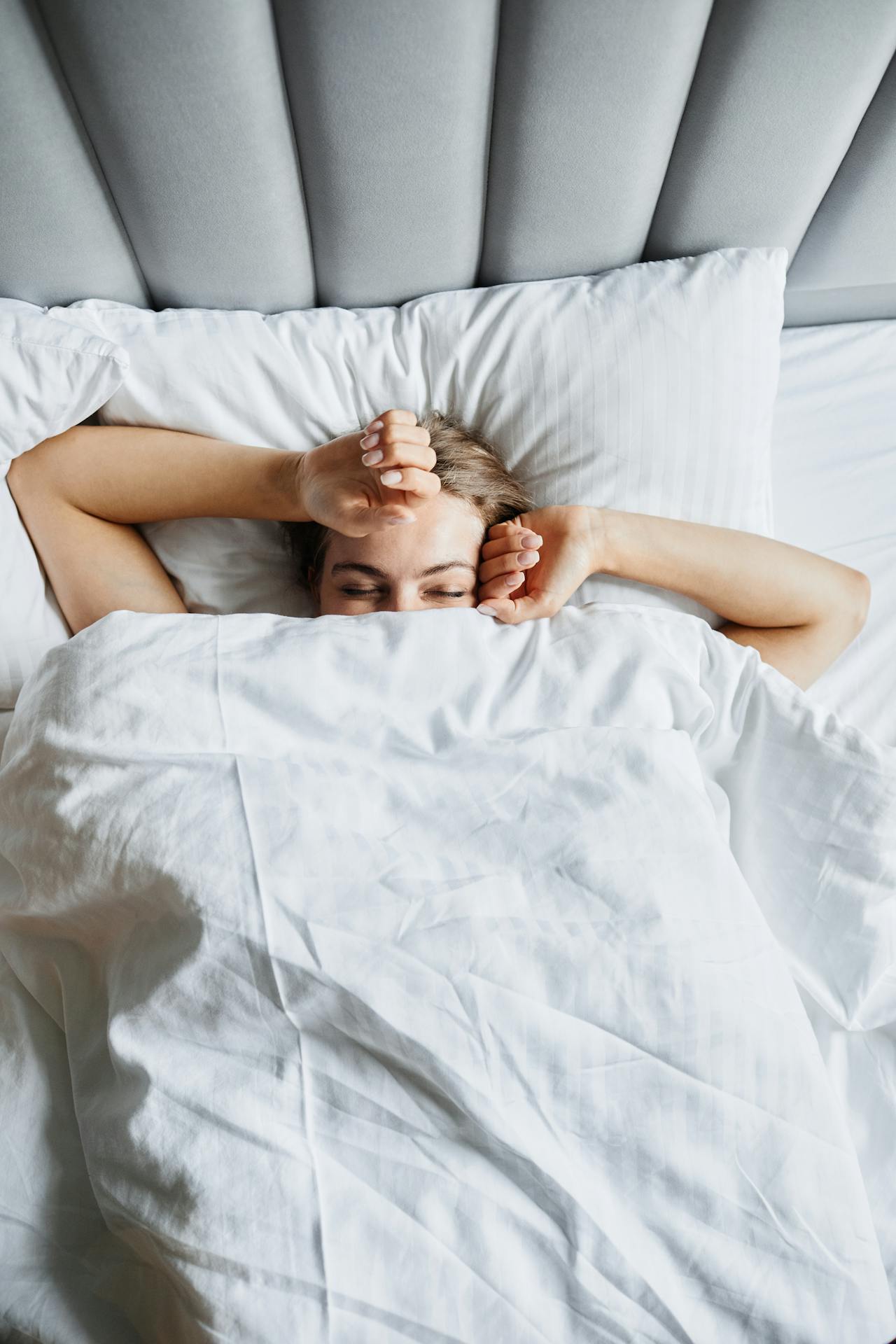 girl-sleeping-under-sheets